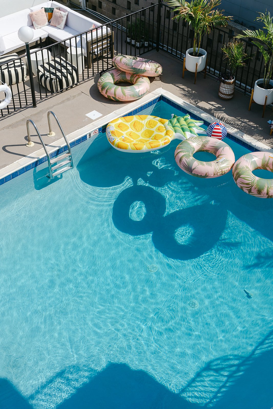 Aerial view of The Shore House pool with colorful floats and lounge area